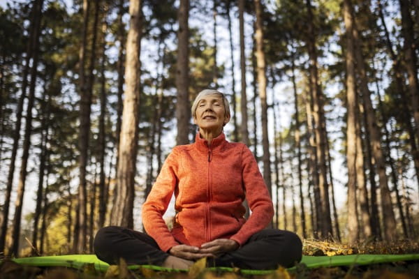 Woman meditating in nature showing a healthy lifestyle and a healthy heart