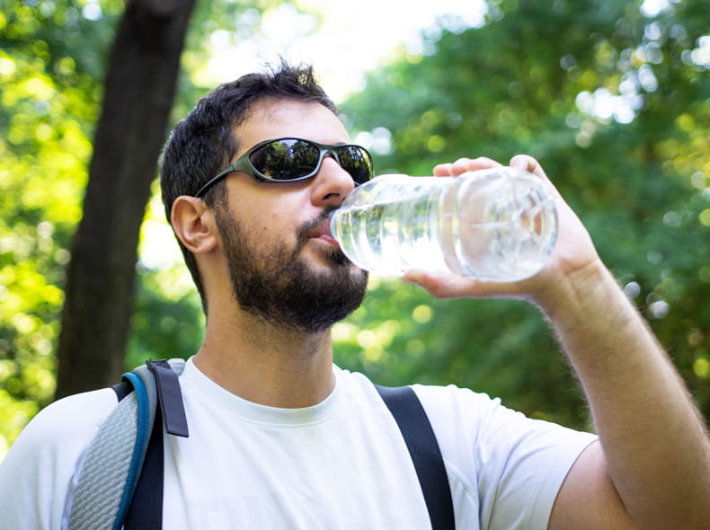 Man drinking a bottle of water.