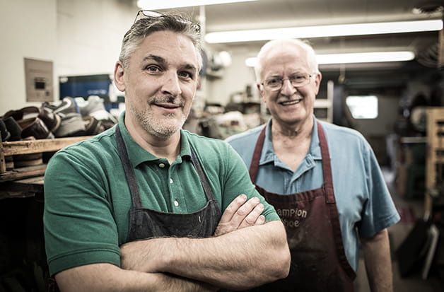Two business owners in aprons
