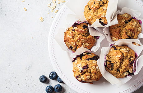 Banana berry muffins on a white plate.