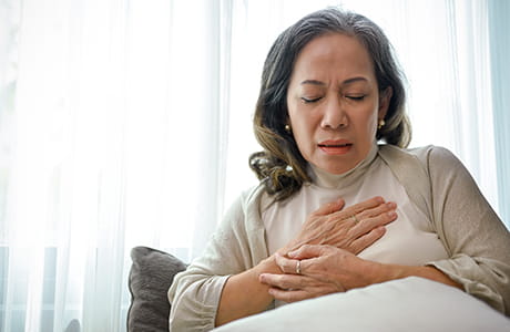 A woman experiencing a heart attack.