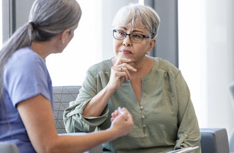Doctor speaking with a senior aged woman.
