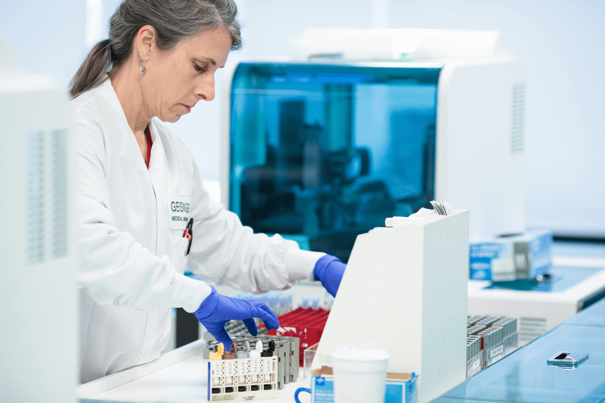 A researcher works in a lab testing fluids