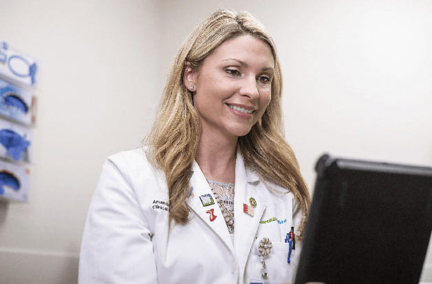 A doctor looking at a tablet