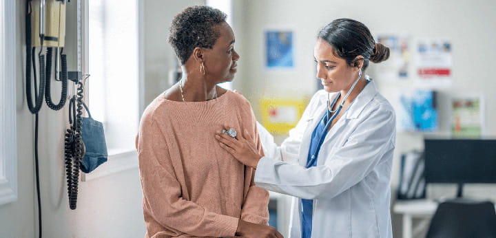 A doctor examines a patient with a stethoscope