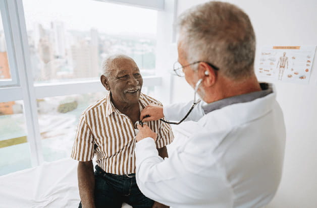 A doctor examines a senior patient with a stethoscope