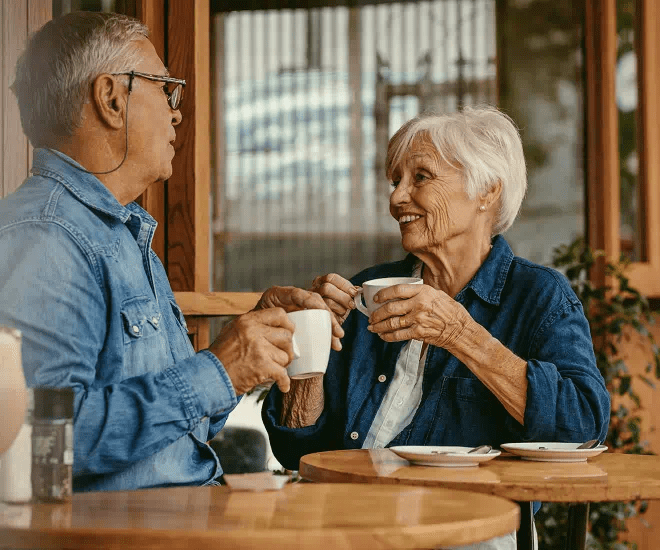 An elderly couple having coffee in a cafe