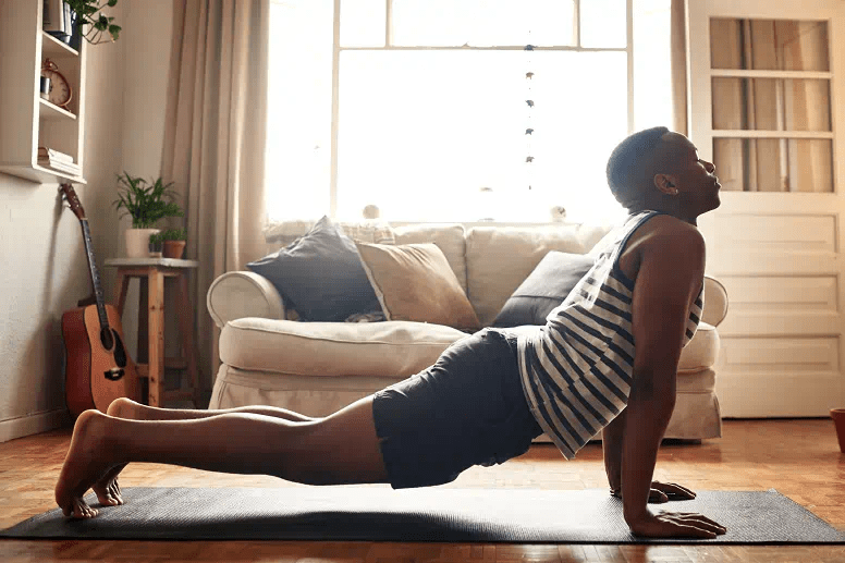 A man performs the cobra yoga pose
