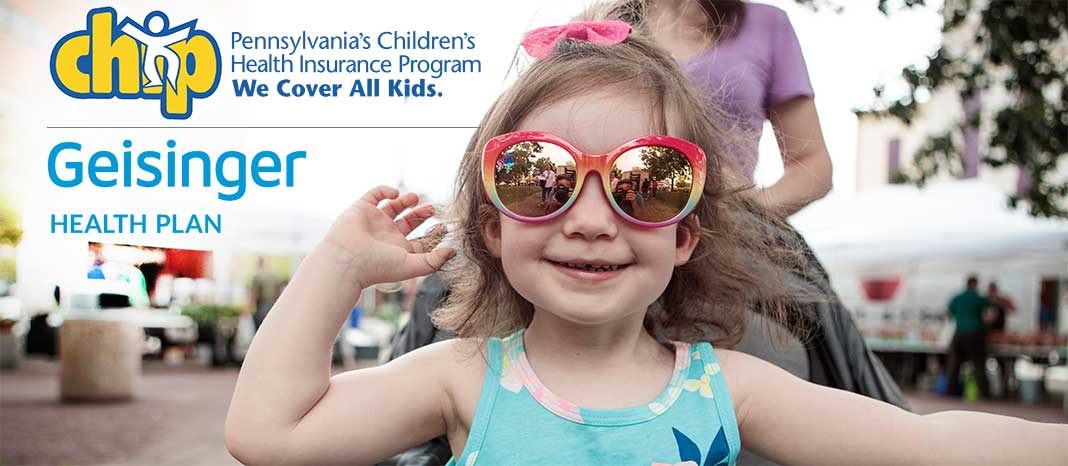 Smiling little girl wearing sunglasses in a stroller